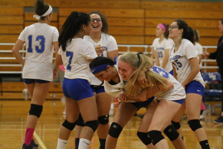 The Westies celebrate after senior Kara Erickson makes a good hit in an October match against Lyman Hall.